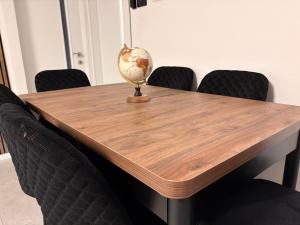 a wooden table with chairs around it with a globe on it at מבית תכלת בית של חופש Allentown 21 אלנטאון 21 in Tiberias +176 photos