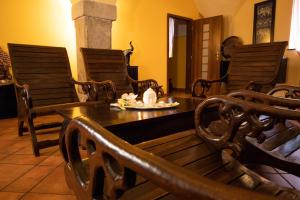 a room with rocking chairs and a wooden bench at Orient Spa in České Budějovice
