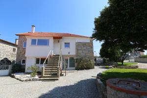 a house with a staircase in front of it at Albergue Ultreya in Esposende +40 photos