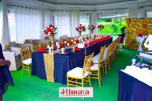 a banquet hall with blue tables and yellow chairs at Himaya Garden in Lanet +134 photos
