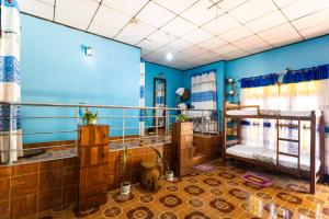 a bathroom with blue walls and a room with sinks at The Bunker Hostel Ella in Ella