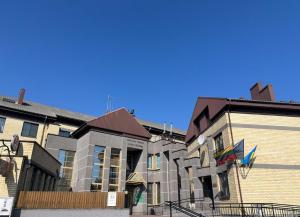 a group of buildings next to each other at Dom Litewski in Sejny