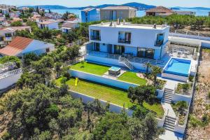 an aerial view of a house with a swimming pool at Villa High Life in Seget Vranjica