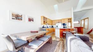 a large kitchen with a wooden table and chairs at Snowcreek V #777 in Mammoth Lakes
