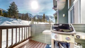 a grill on a balcony with a view of the mountains at Snowcreek V #777 in Mammoth Lakes