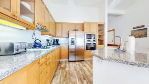 a kitchen with wooden cabinets and stainless steel appliances at Snowcreek V #777 in Mammoth Lakes