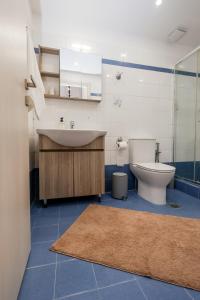a bathroom with a sink and a toilet at Via Basta in Koroni +42 photos