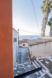 a walkway between two buildings with a view of the ocean at Via Basta in Koroni