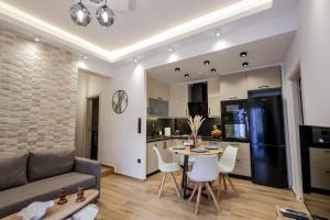 a living room with a couch and a table and chairs at Via Basta in Koroni