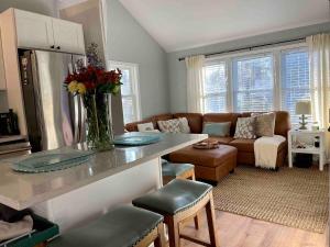 a kitchen and living room with a vase of flowers on a counter at The Beach Gallery in Narragansett