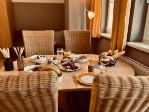a table with plates of food and glasses of wine at Villa Florl in Schladming