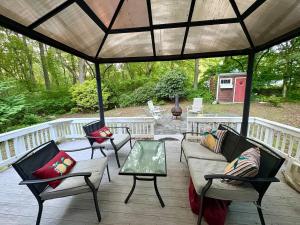 a porch with chairs and a couch and a table at The Beach Gallery in Narragansett