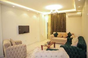 a living room with two couches and a tv at الزقازيق in Kafr Muḩammad Ḩusayn