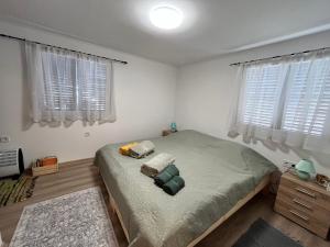 a bedroom with a bed and two pillows on it at Kicsi Rigó Nyaralóház in Lakitelek