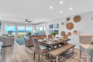 a living room with a table and chairs and a couch at 201 Surfside in Clearwater Beach