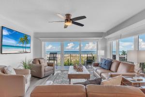a living room with a couch and a ceiling fan at 201 Surfside in Clearwater Beach