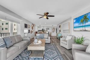 a living room with a couch and a ceiling fan at 201 Surfside in Clearwater Beach +42 photos