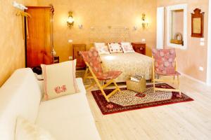 a bedroom with a bed and two chairs at Casa in Bioedilizia con Bio Piscina Naturale – Ai Due Gelsi in Grancona