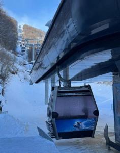 a suitcase hanging from a ski lift in the snow at Nest 316 Bela Reka Kopaonik in Brzeće