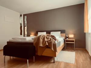 a bedroom with a large bed with a brown blanket on it at Dependance I in Schladming