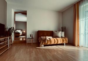 a bedroom with a bed and a living room at Dependance I in Schladming +8 photos