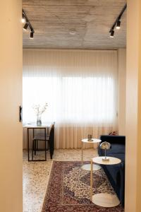 a living room with a couch and tables and a window at Echoes of Thrace in Xanthi