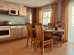 a kitchen with a table and chairs in a kitchen at Dependance I in Schladming
