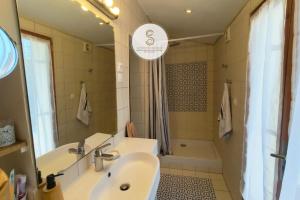 a bathroom with a sink and a shower and a tub at Les Alys Arles Centre in Arles +24 photos