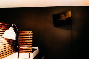 a lamp in a room with a black wall at Sol Sage Studio Downtown in Wilmington