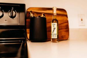 a bottle of wine sitting on a counter next to a stove at Sol Sage Studio Downtown in Wilmington