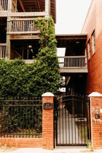 a building with a gate in front of a building at Sol Sage Studio Downtown in Wilmington