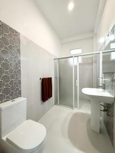 a bathroom with a shower and a toilet and a sink at Villa Olga in Unawatuna +64 photos