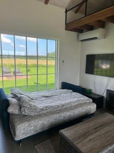 a bedroom with a bed and a large window at Nice getaway, 20 min from Tallinn in Järsi