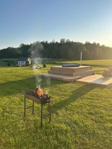 a fire pit in the middle of a field at Nice getaway, 20 min from Tallinn in Järsi