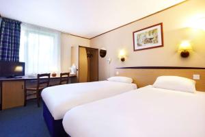 a hotel room with two beds and a desk at The Raceby Hotel, Doncaster South Yorkshire, Part of the AG Collection in Doncaster