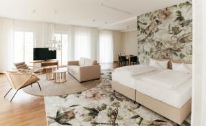a bedroom with a bed and a living room at B&O Parkhotel in Bad Aibling +72 photos
