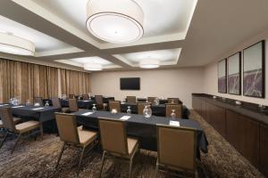 a conference room with a large table and chairs at Holiday Inn Chicago Schaumburg, an IHG Hotel in Schaumburg