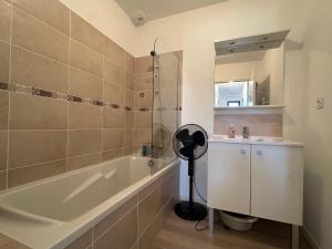a bathroom with a tub and a sink and a mirror at Les cabines de Granville in Granville +7 photos