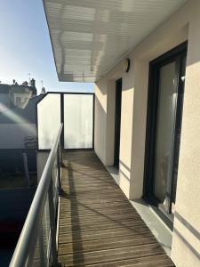 a balcony of a building with a wooden walkway at Les cabines de Granville in Granville