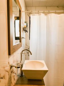 a bathroom with a white sink and a mirror at Cabañas Lihuen in Caviahue