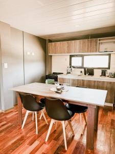 a kitchen with a large wooden table and chairs at Cabañas Lihuen in Caviahue +7 photos