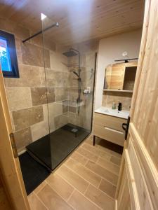 a shower with a glass door in a bathroom at Le Chalet in Selonnet +46 photos