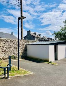a parking lot with a building and a street light at Duplex Hermine Cosy, jardin sud & parking in Saint Malo