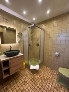 a bathroom with a shower and a sink and a tub at Gästehaus Gastl in Mieming +38 photos