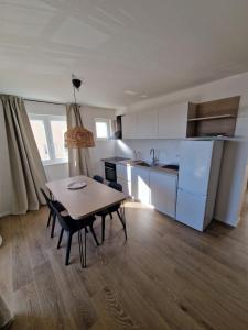 a kitchen with a table and chairs in a room at Apartmani Tribunj Cvitan in Tribunj