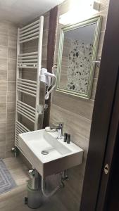 a bathroom with a white sink and a mirror at Varosi Guesthouse in Edessa +74 photos