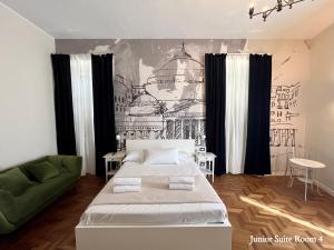 a bedroom with a bed and a green couch at Be Your Home - Guest House Fuori Dal Porto in Civitavecchia