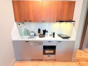 a small kitchen with a sink and a stove at Amaroo - Boarding & Serviced Apartments "Regia" in Potsdam