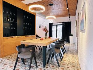 a dining room with a wooden table and chairs at Alexa Mountain Homes in Kok-Shoky