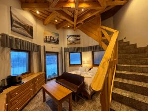 a bedroom with a staircase and a bed and a room with a stair case at Rezidence u Jezera in Jeseník +61 photos